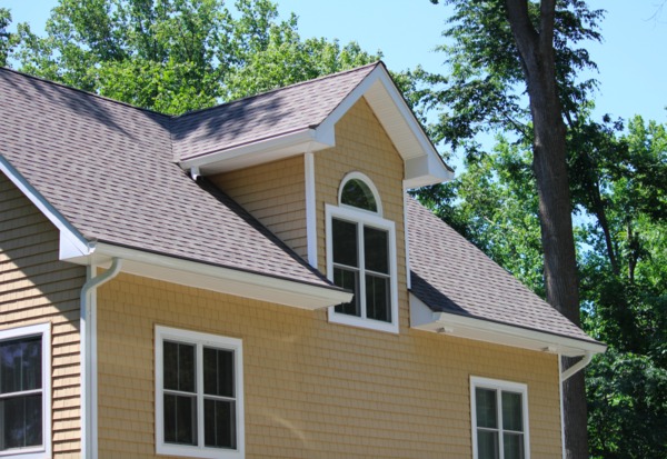 Tan home with white trim and gutters.